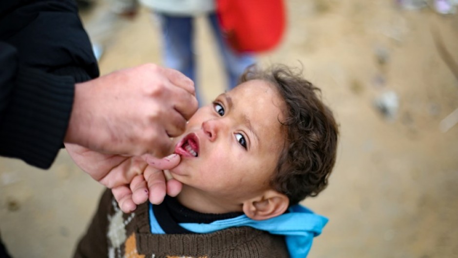 Children received polio vaccine doses at a camp for displaced people in Nuseirat
