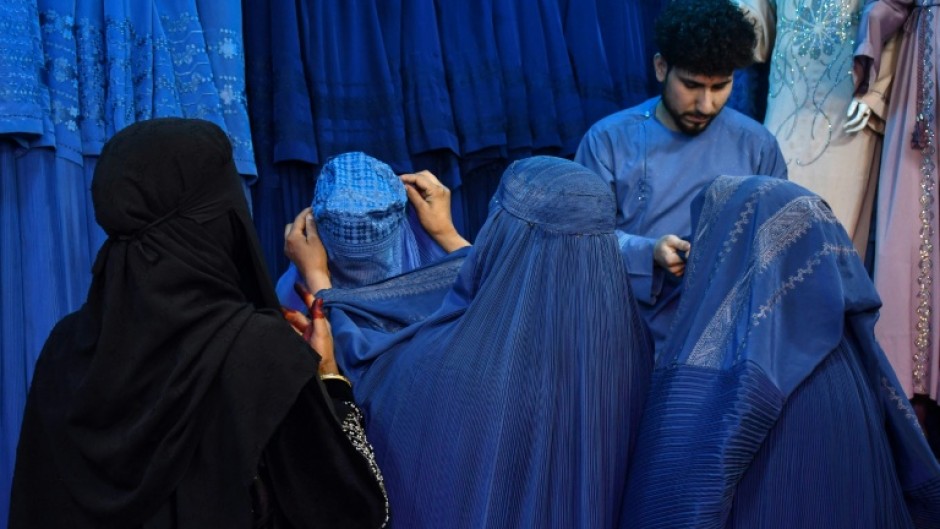 Afghan women buy burqas at a shop in Mazar-i-Sharif. When the Taliban recaptured Kabul in 2021, they had promised to be more flexible than during their first rule