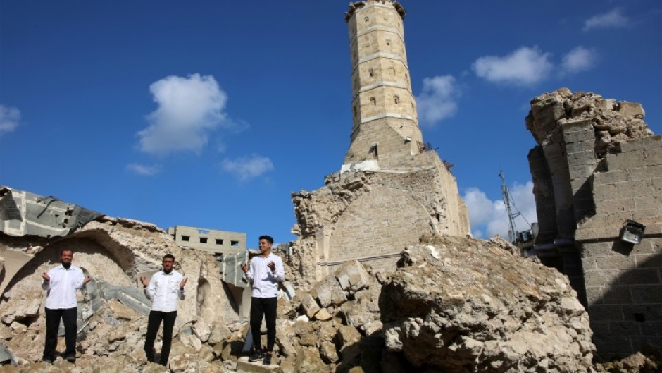 Palestinians pray amid the rubble of Gaza City's historic Omari Mosque.