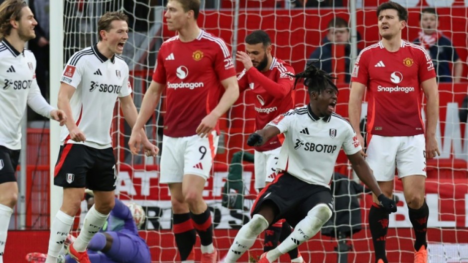 Calvin Bassey (2R) celebrates his FA Cup goal for Fulham against Manchester United at Old Trafford

