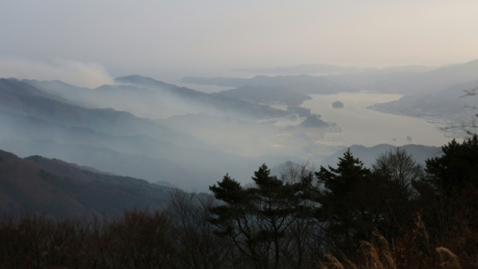 Smoke rises from a wildfire near Ofunato Bay in Iwate Prefecture