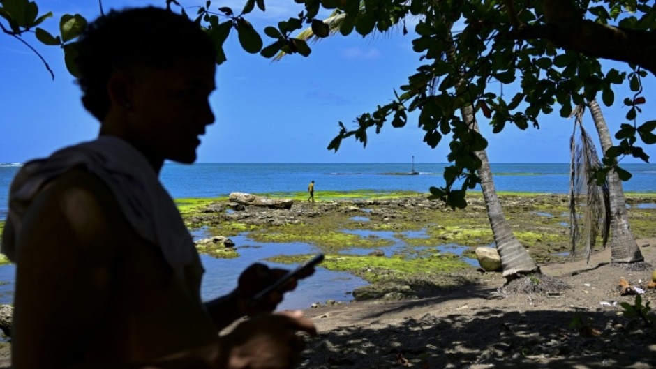 A Venezuelan migrant waits on the beach in Panama for a boat to Colombia