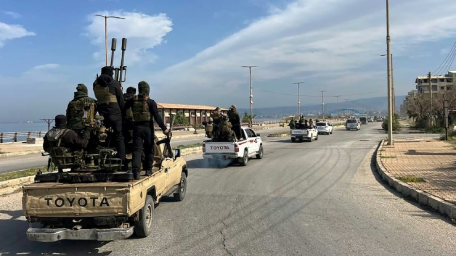 A convoy of troop reinforcements enters the Syrian coastal city of Baniyas after deadly clashes rocked the Mediterranean heartland of ousted president Bashar al-Assad's Alawite minority.