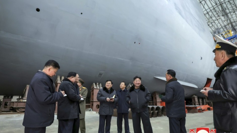 North Korean leader Kim Jong Un (3rd R) visited shipyards focused on building warships, the Korean Central News Agency reported