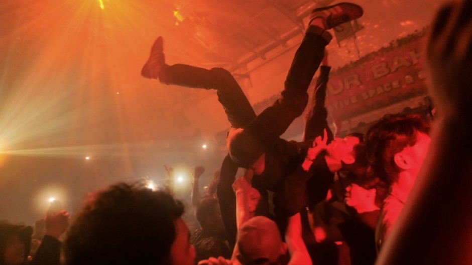 At a smoke-filled warehouse in Jakarta hundreds of Indonesians party to the sounds of 1990s Britain