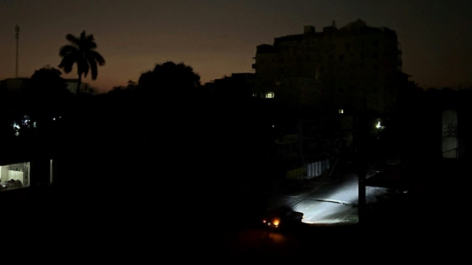 Car lights illuminate a street in Havana, Cuba during a widespread electricty blackout that hit much of the island nation