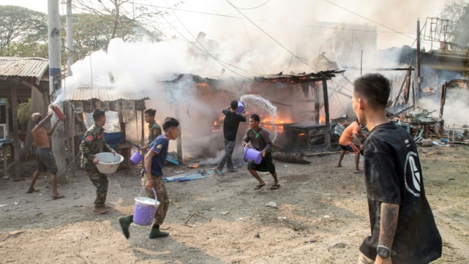 People trying to put out fires in Singu