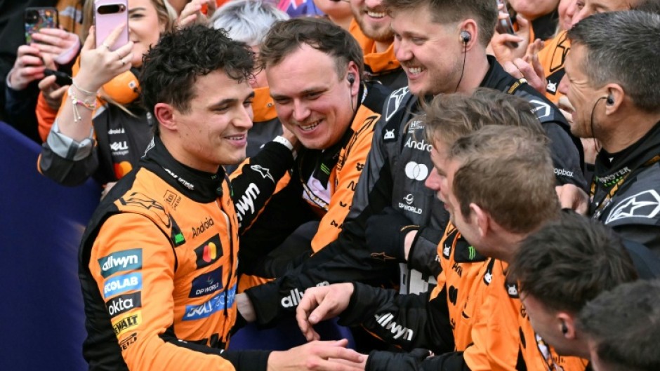 Lando Norris (left) celebrates with his McLaren team after winning the Australian Grand Prix