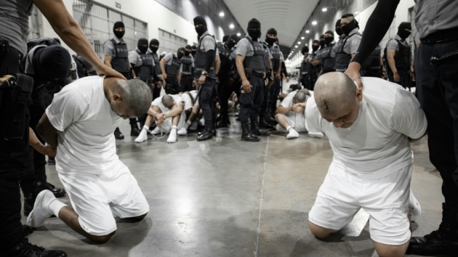 A handout picture released by El Salvador's Presidency press office shows alleged members of the Venezuelan criminal organization Tren de Aragua at the Terrorism Confinement Center