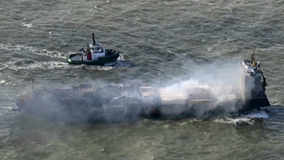 A tugboat accompanies the stricken Solong cargo ship following a devastating crash in the North Sea off the Yorkshire coast