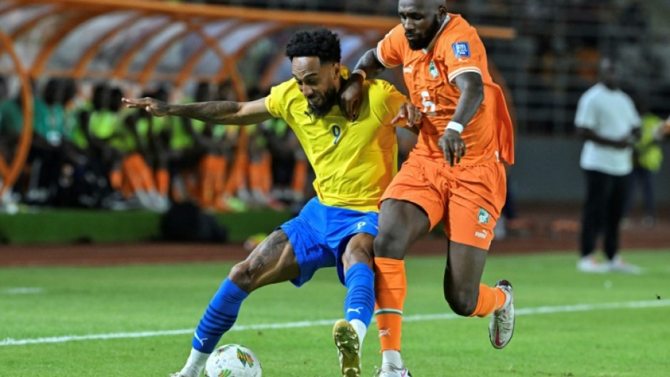 Gabon star Pierre-Emerick Aubameyang (L) fights for the ball during a 2026 World Cup qualifier against Ivory Coast.