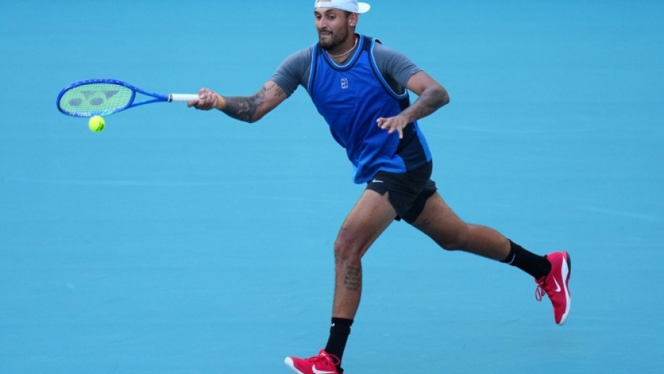 Nick Kyrgios returns a shot against Mackenzie McDonald en route to his first win since 2022