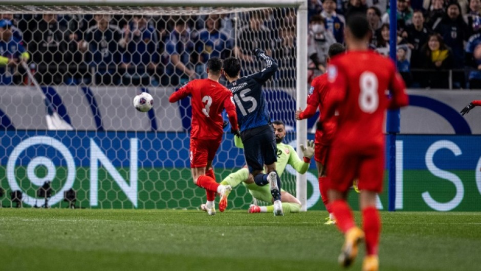Japan's Daichi Kamada scores for the hosts