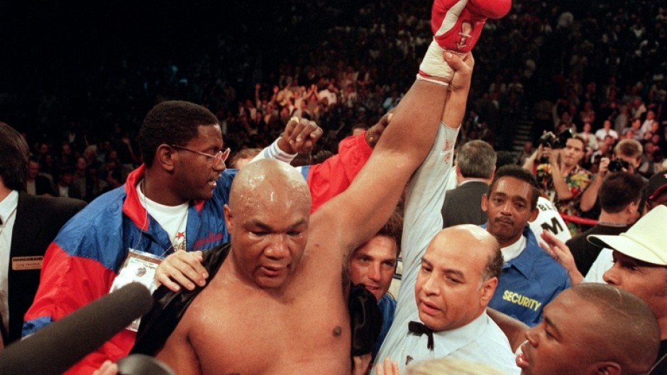 George Foreman raises his arm aloft after defeating Michael Moorer to recapture the heavyweight title in 1994