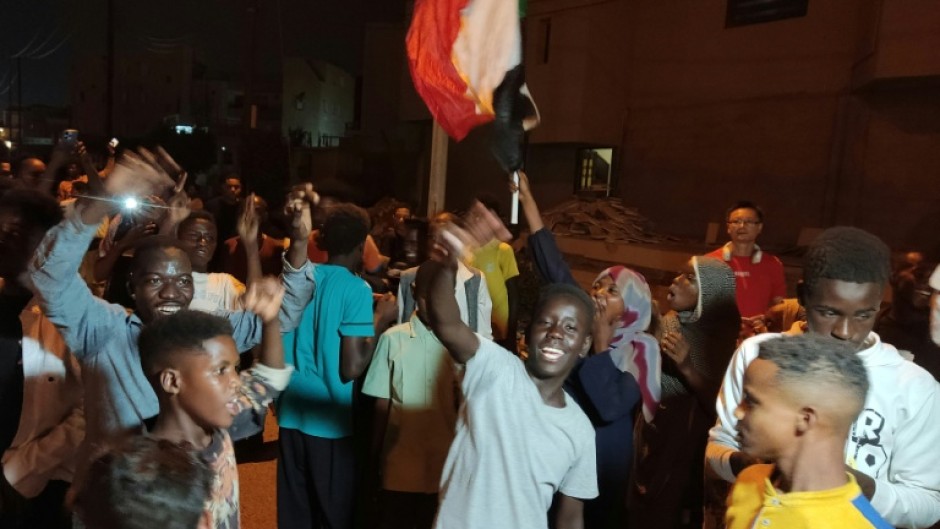 People take to the streets of Port Sudan to celebrate the army's recapture of the capital Khartoum