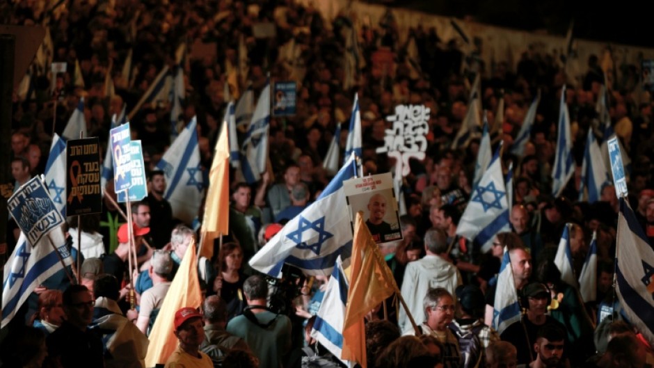 Israelis rally outside the parliament in Jerusalem on March 26, 2025, calling for an end to the war in Gaza, the return of all the hostages held by Hamas and against judicial reforms