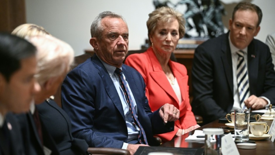 US Secretary of Health and Human Services Robert F. Kennedy Jr. (C) speaks as US President Donald Trump hosts (L) hosts a cabinet meeting in the Cabinet Room of the White House on March 24, 2025