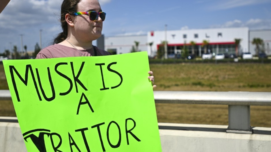 Demonstrators denounce Tesla CEO Elon Musk in Clermont, Florida, part of a day of protest against the tech billionaire on March 29, 2025