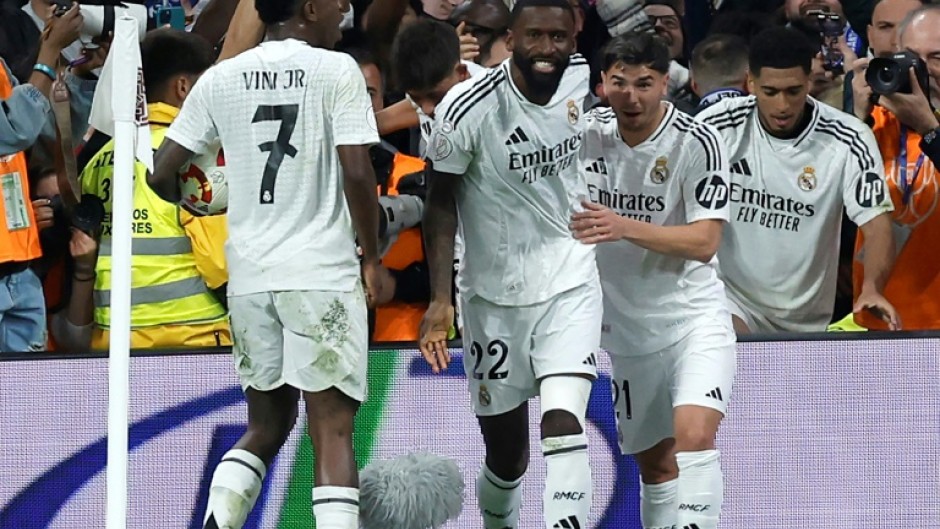 Real Madrid's German defender Antonio Rudiger (C) celebrates scoring his team's fourth goal against Real Sociedad