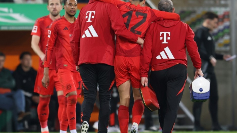 Bayern Munich midfielder Jamal Musiala is helped from the field with a hamstring injury