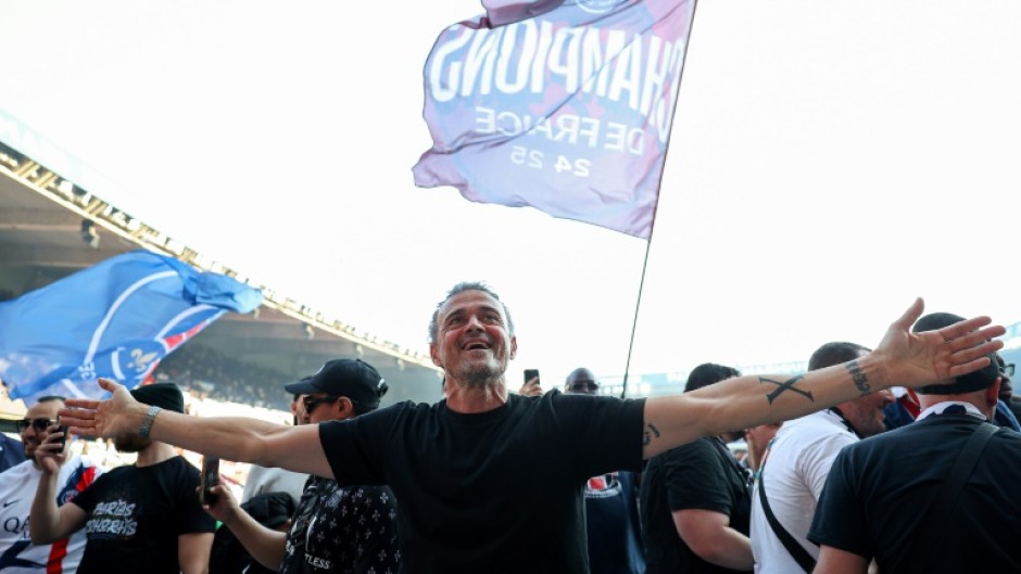 PSG coach Luis Enrique leads the celebrations after his side clinched the Ligue 1 title on Saturday