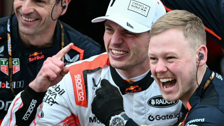 Max Verstappen (white cap) celebrates victory with his team members after the Japanese Grand Prix