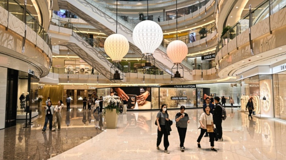 People walk in the IFC mall at the financial district in Shanghai