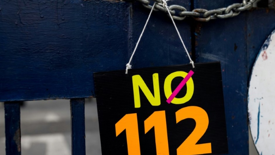 A sign is displayed outside the Criminal Court during a protest against article 112, Thailand's lese majeste royal defamation law