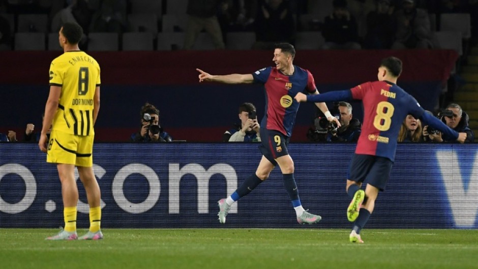 Barcelona's Polish forward Robert Lewandowski (C) celebrates scoring his team's second goal in the rout of Dortmund