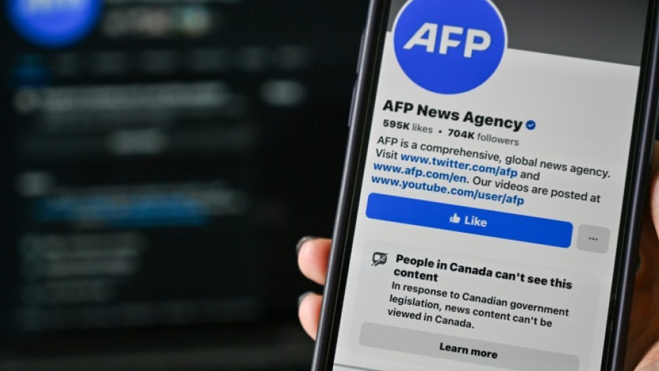 This illustration photo taken on April 14, 2025, in Montreal, Canada, shows the alert: “People in Canada can’t see this content” on the Facebook page of news organization Agence France-Presse (AFP)