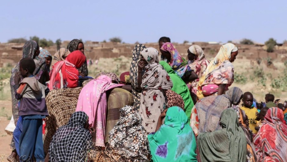 Displaced Sudanese women and children gather at a camp near the town of Tawila in North Darfur on February 11, 2025