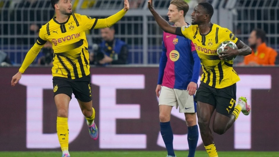 Serhou Guirassy (R) scored a hat-trick but was unable to help his side come back against Barcelona