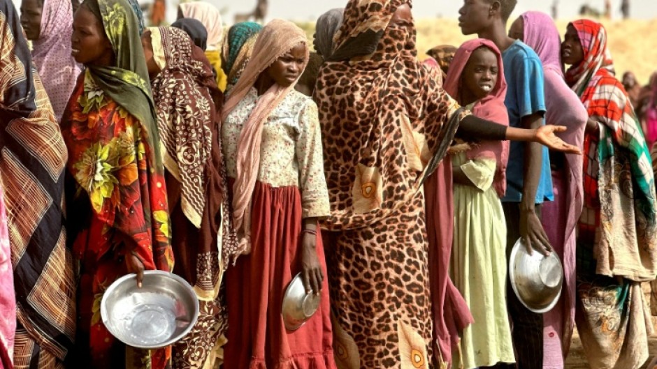 People who fled the Zamzam camp for the internally displaced after it fell under RSF control waiting for food rations at a makeshift encampment in western Darfur