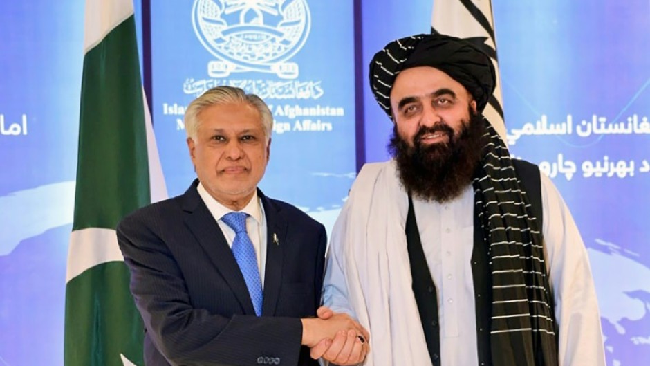 Pakistan Foreign Minister Ishaq Dar (L) with his Afghan counterpart Amir Khan Muttaqi during a visit to Kabul