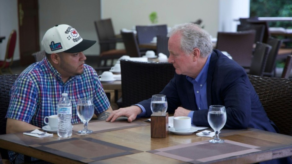 A photo posted on social media by US Senator Chris Van Hollen (R) shows him meeting with Salvadoran migrant Kilmar Abrego Garcia (L), a US resident deported to his home country, at a hotel in San Salvador, El Salvador, on April 17, 2025