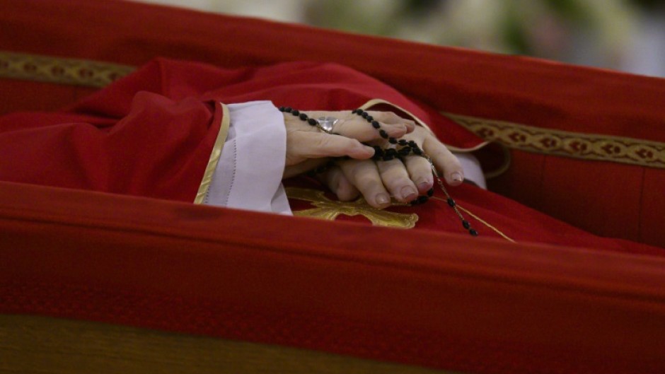 Pope Francis's body was placed in an open coffin before its removal to lie in state in the Vatican