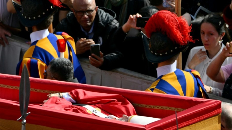 Pallbearers, next to Swiss Guards, carry the coffin of Pope Francis as it is transported from the chapel of Santa Marta to St Peter's Basilica