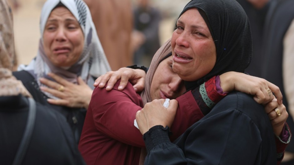 Palestinians mourn during a funeral of relatives killed in an Israeli strike on a school-turned-shelter at the Al-Shifa hospital in Gaza City