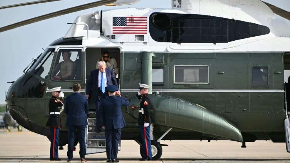US President Donald Trump and First Lady Melania Trump step off Marine One upon arrival at Joint Base Andrews