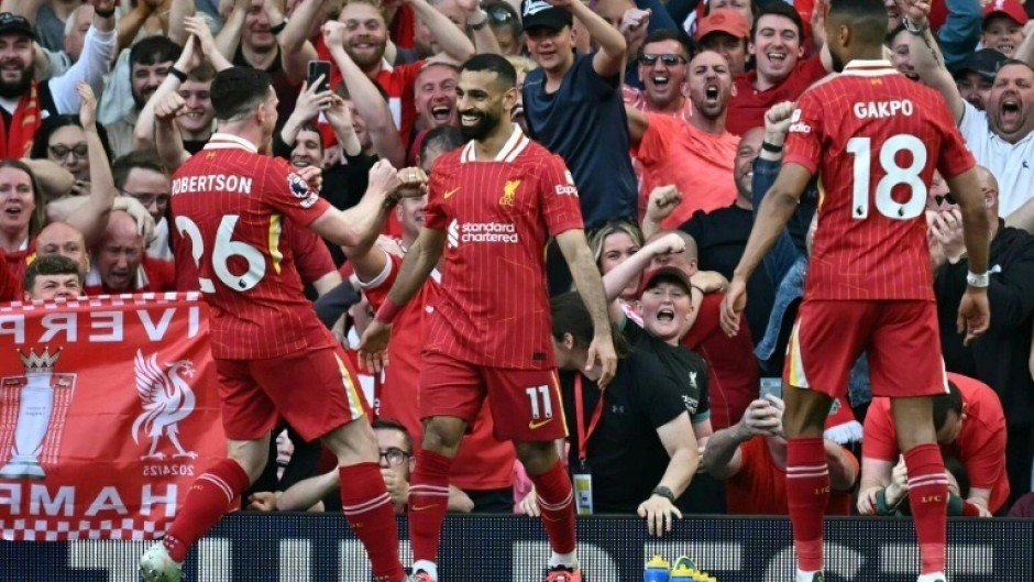 Mohamed Salah (C) celebrates scoring for Liverpool againt Tottenham Hotspur at Anfield
