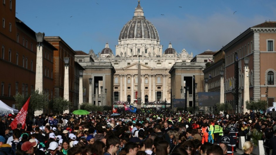 People gather along Via della Conciliazione street ahead of late Pope Francis' funeral ceremony