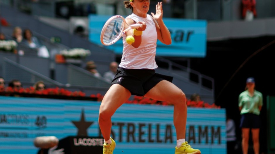 Iga Swiatek returns the ball during her Madrid Open quarter-final defeat of Madison Keys