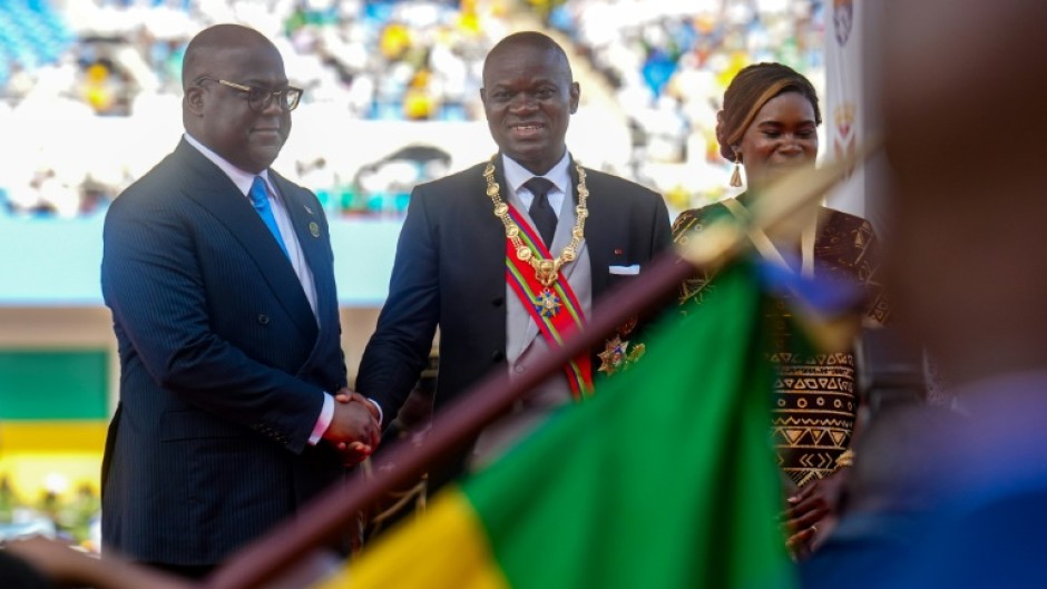 Oligui (C) was sworn in in a ceremony attended by numerous African leaders, including the president of the Democratic Republic of Congo Felix Tshisekedi (L)