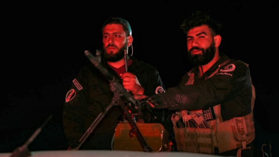 Syrian security forces at a checkpoint in Jaramana near Damascus early on May 2