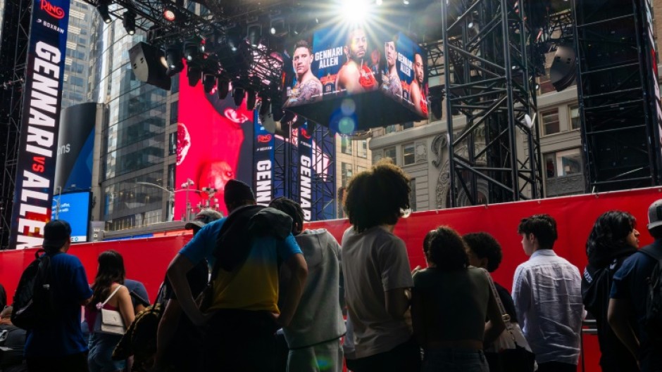 People gather around the outdoor boxing ring erected in Times Square for the fight card featuring Ryan Garcia's return from a doping suspension