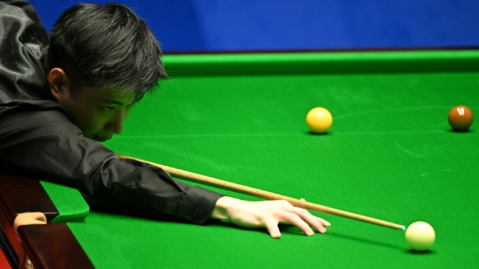 China's Zhao Xintong plays a shot at the World Snooker Championship in 2022