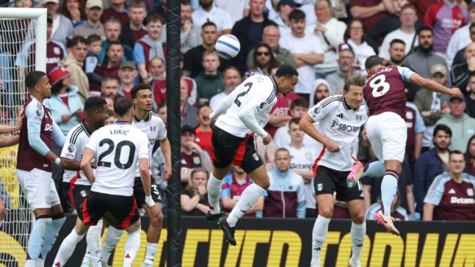 Aston Villa's Youri Tielemans (R) heads the winner against Fulham