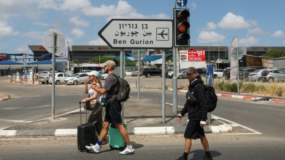 Travellers enter Israel's Ben Gurion airport after air defences were activated against a missile launched from Yemen