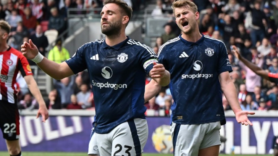 Manchester United's Luke Shaw (L) reacts after scoring an own goal against Brentford