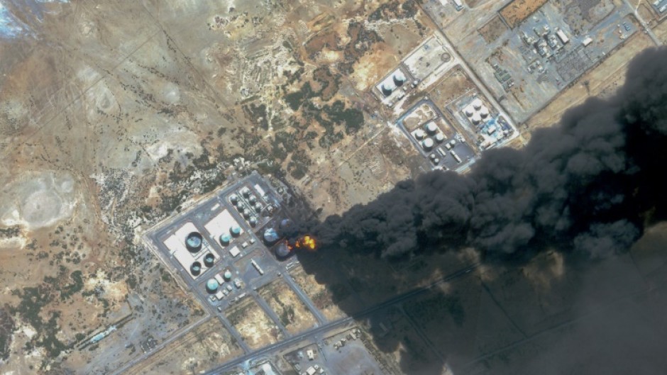 A handout satellite photo from Planet Labs PBC dated May 6 shows smoke billowing from a fuel storage depot in Port Sudan